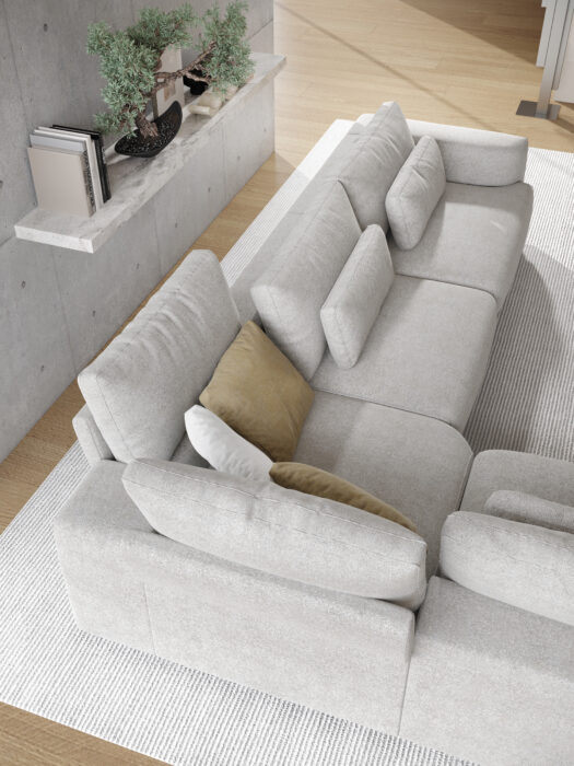 A Canapé Willow [4z-Nzz-4z] - C25 Perfect Harmony en gris clair avec des coussins beiges et gris est posé sur un tapis texturé blanc. Derrière, une étagère en béton inspirée de C25 Perfect Harmony accueille des livres, une petite plante et des objets de décoration.