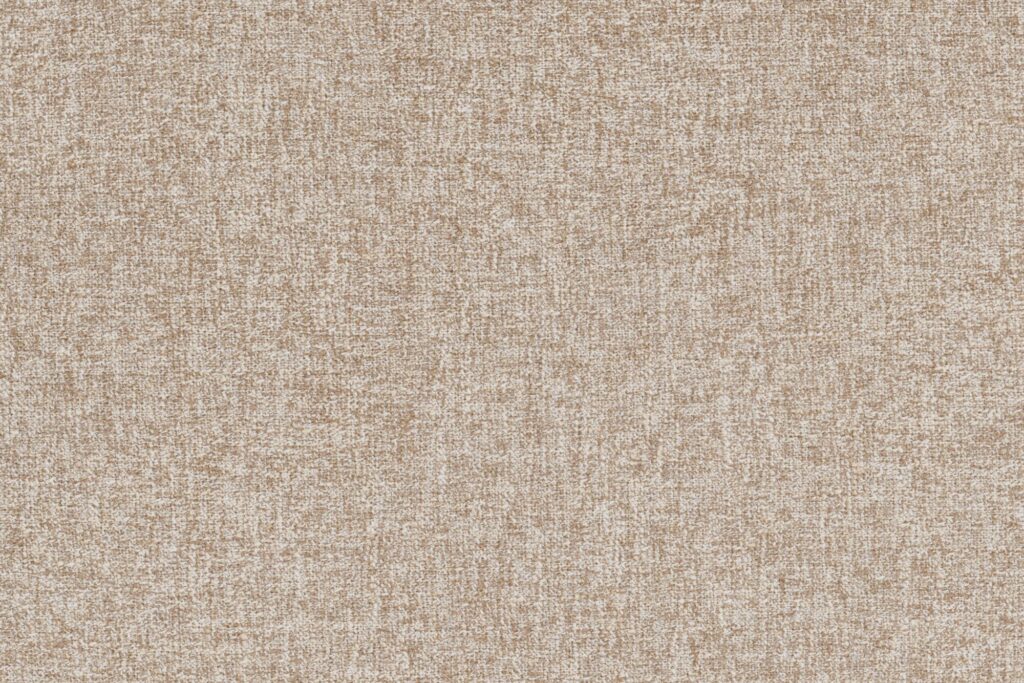 Gros plan sur la surface texturée d'un tissu bouclé beige avec un motif tissé, présentant un mélange de fils clairs et foncés uniformément répartis sur toute la surface - idéal pour le siège d'angle Sumo.