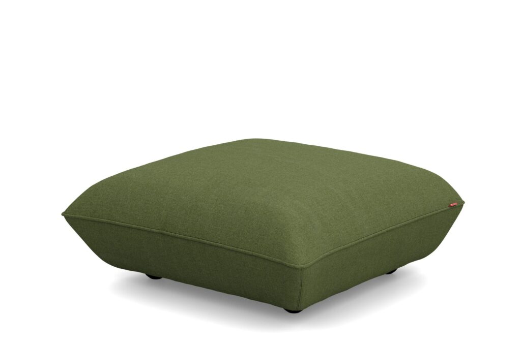 Un pouf carré en tissu vert aux bords légèrement arrondis, inspiré du style Sumo Hocker, repose sur de petits pieds noirs sur fond blanc.
