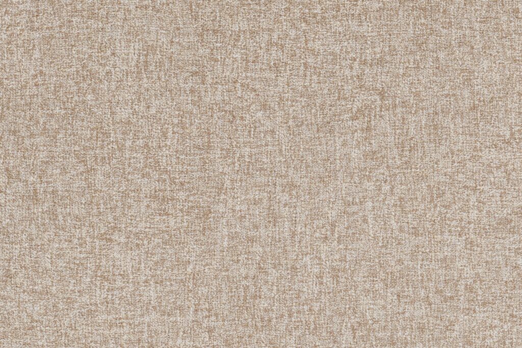 Gros plan sur un tissu beige texturé avec un motif tissé, avec des fils clairs et foncés - idéal pour recouvrir le Sumo - Loveseat et ajouter du confort à vos sièges.