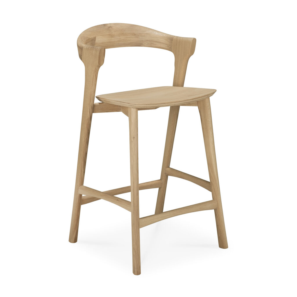 Tabouret de bar en bois clair Bok au dossier incurvé et au design minimaliste, avec un dossier ouvert et quatre pieds angulaires reliés par des supports transversaux.