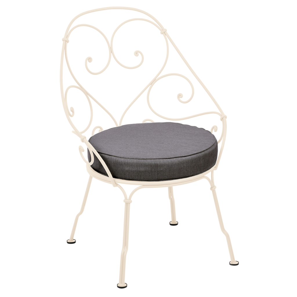 Une chaise en métal blanc avec des volutes décoratives et un coussin d'assise rond gris foncé évoque le charme d'un Fauteuil Cabriolet 1900, alliant l'élégance des fauteuils anciens au style moderne.